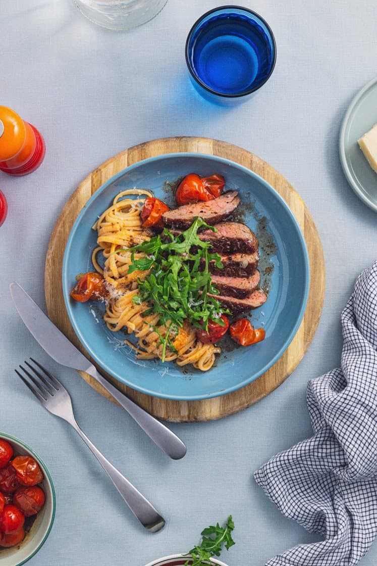 Oksetykstegsbøffer med tomat- og chilicremet pasta, balsamicobagte cherrytomater og Grande Premium
